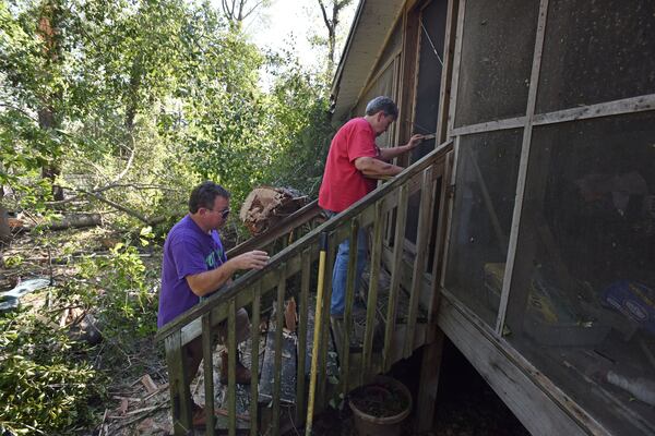 October 11, 2018 Roberta - Sally McRorie and her son Bradley Lewis bring hamburger patties in for friends who are helping cleaning damages around their home at the corners of GA-128 and Flint River Estates Road in Roberta on Thursday, October 11, 2018. Tropical Storm Michael swept out of Georgia before sunrise, leaving a trail of destruction in its wake. HYOSUB SHIN / HSHIN@AJC.COM