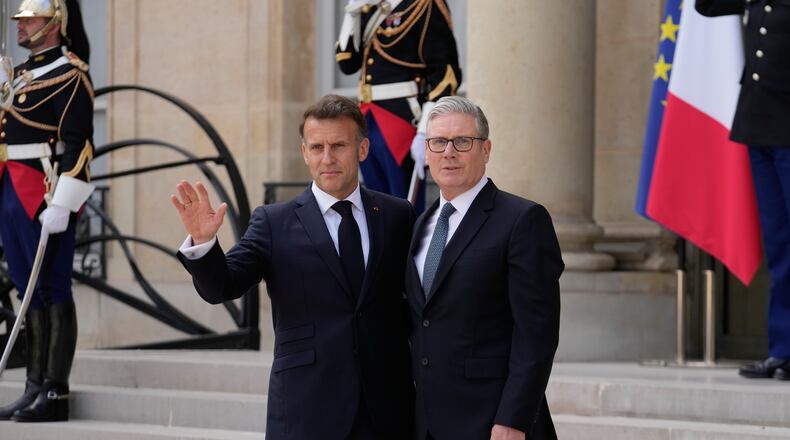 France's President Emmanuel Macron, left, welcomes British Prime Minister Keir Starmer prior to an international summit to push forward efforts to reopen the Strait of Hormuz, at the Elysee Palace, in Paris, France, Friday, April 17, 2026. (AP Photo/Michel Euler)