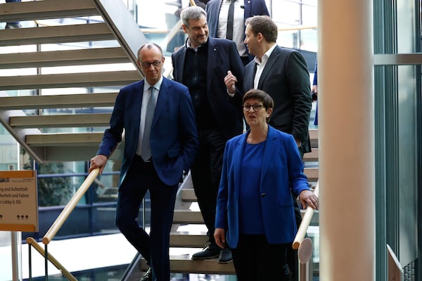 CDU leader Friedrich Merz, left, chairman of Bavarian Christian Social Union party Markus Soeder, center left, and the co-leaders of Germany's Social Democratic Party Lars Klingbeil, top right, and Saskia Esken arrive to attend coalition talks between SPD CDU/CSU at the SPD headquarters in Berlin, Friday March 28, 2025. (Odd Andersen/Pool via AP)