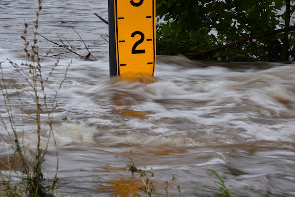 A flood gauge marks the height of water flowing over a farm-to-market road near Kerrville, Texas, on Friday, July 4, 2025. (AP Photo/Eric Gay)