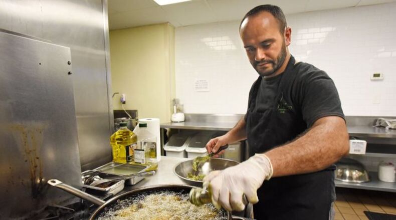 Samer, a Syrian refugee who asked that his last name not be published, makes falafel in a Mediterranean restaurant in downtown Atlanta. The war caused him to flee with his wife and newborn son to Jordan. HYOSUB SHIN / HSHIN@AJC.COM
