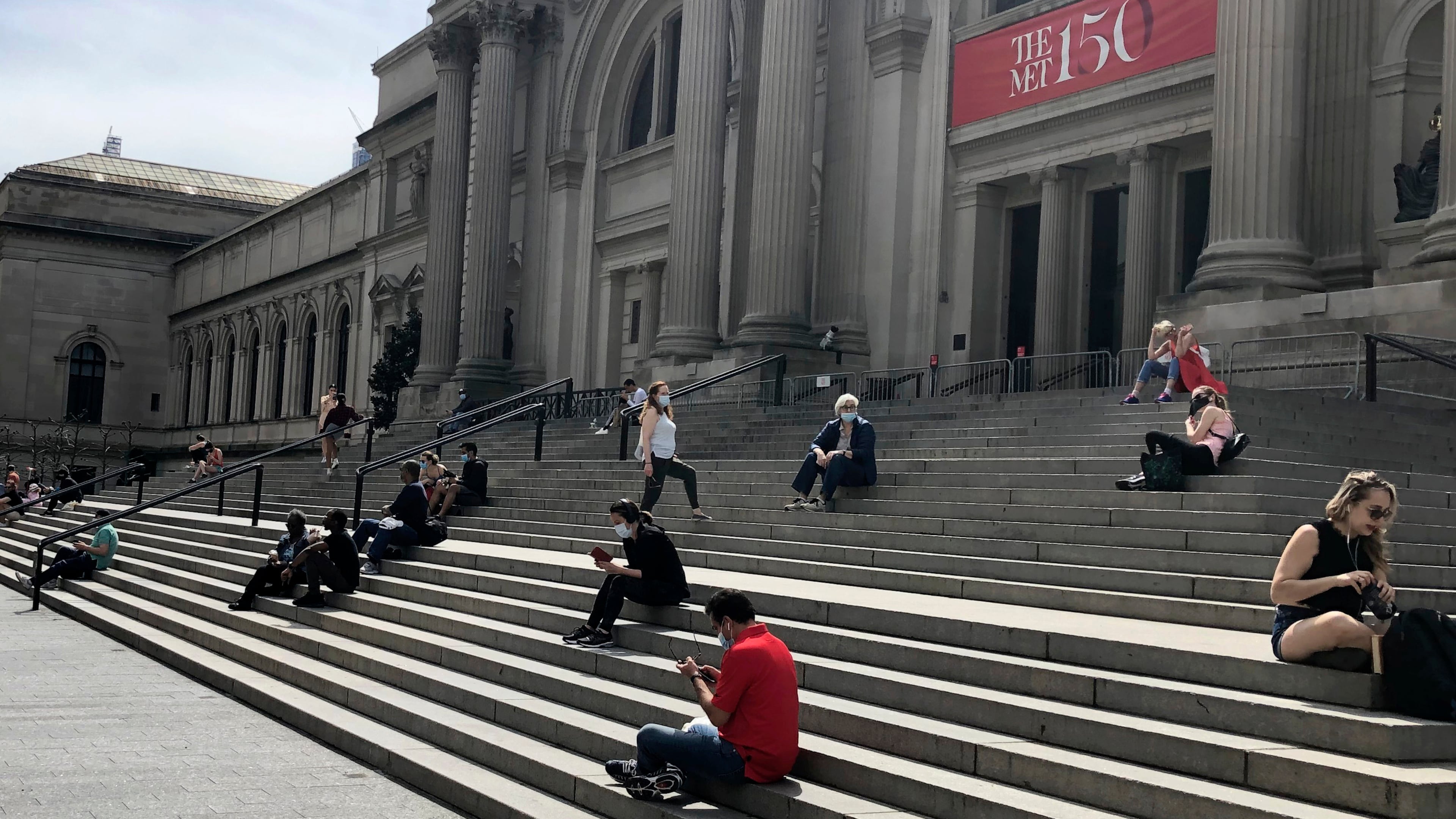 FILE - People sit outside the Metropolitan Museum of Art on May 2, 2020 in New York. (AP Photo/Ron Blum, file)
