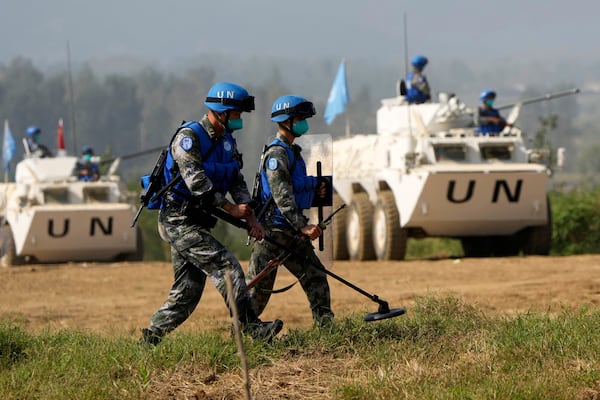 FILE - Chinese United Nations troop practice sweeping for mines during the Shared Destiny 2021 drill at the Queshan Peacekeeping Operation training base in Queshan County in central China's Henan province Sept. 15, 2021. (AP Photo/Ng Han Guan, File)