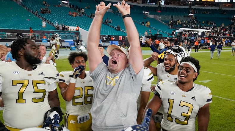 Georgia Tech coach Brent Key, center, celebrates with players after they beat Miami 23-20 during an NCAA college football game, Saturday, Oct. 7, 2023, in Miami Gardens, Fla. (AP Photo/Wilfredo Lee)