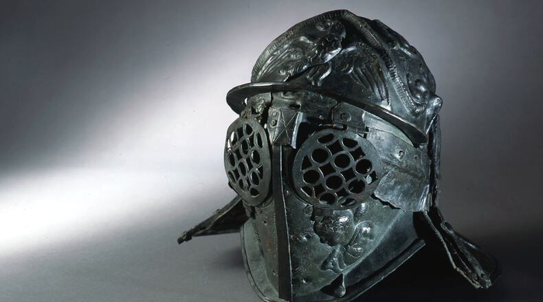 This bronze first century helmet of a gladiator from the barracks of Pompeii is part of the new traveling exhibition “Gladiators: Heroes of the Colosseum” at the Fernbank Museum of Natural History through Jan. 7. CONTRIBUTED BY: Museo Archeologico Nazionale