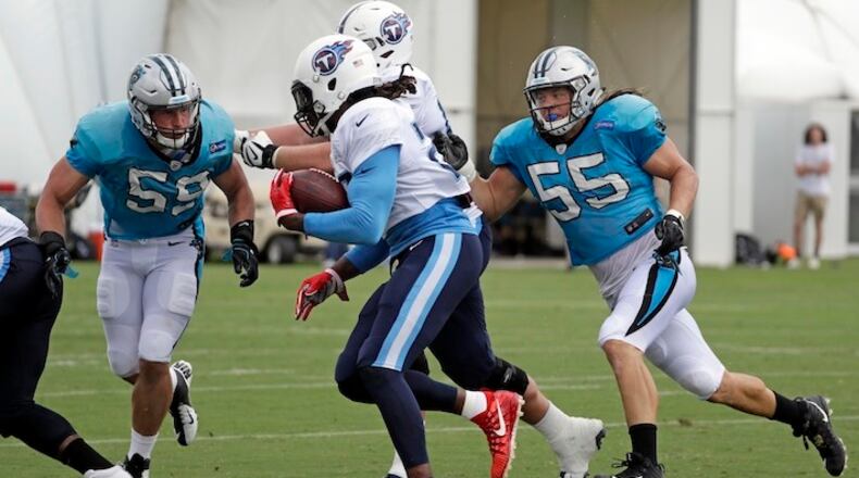Carolina Panthers middle linebacker Luke Kuechly (59) and linebacker David Mayo (55) close in on Tennessee Titans running back Derrick Henry, center, during a combined NFL football training camp Thursday, Aug. 17, 2017, in Nashville, Tenn. (AP Photo/Mark Humphrey)