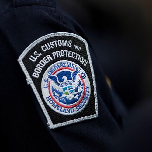 FILE - A customs agent wears a patch for the U.S. Customs and Border Protection agency, Oct. 27, 2017, at John F. Kennedy International Airport in New York. (AP Photo/Mark Lennihan, file)