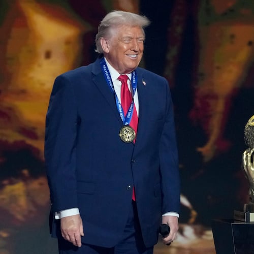 President Donald Trump smiles after being awarded the FIFA Peace Prize during the draw for the 2026 soccer World Cup at the Kennedy Center in Washington, Friday, Dec. 5, 2025. (AP Photo/Chris Carlson)