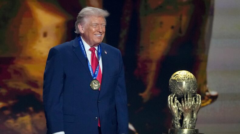 President Donald Trump smiles after being awarded the FIFA Peace Prize during the draw for the 2026 soccer World Cup at the Kennedy Center in Washington, Friday, Dec. 5, 2025. (AP Photo/Chris Carlson)