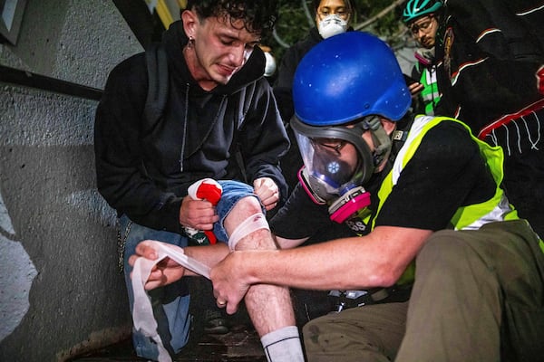 An injured person is tended to during protests over the Trump administration's immigration raids in Los Angeles, Monday, June 9, 2025. (AP Photo/Ethan Swope)