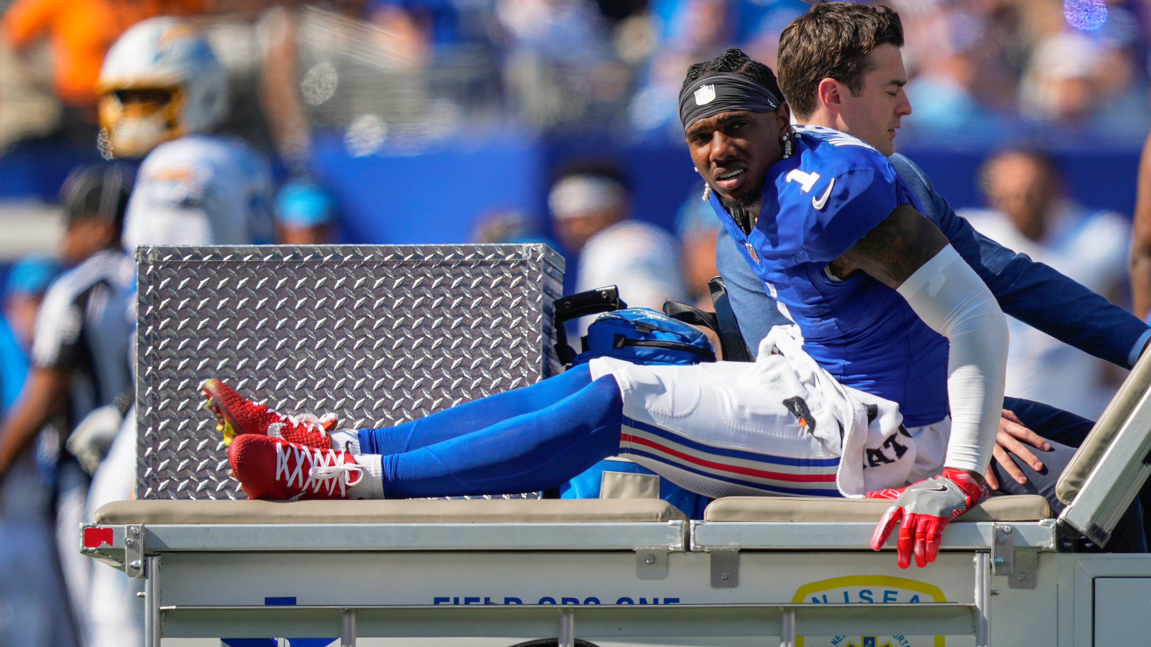 New York Giants wide receiver Malik Nabers (1) is driven off the field by medical personnel after an injury during the second quarter of an NFL football game against the Los Angeles Chargers, Sunday, Sept. 28, 2025, in East Rutherford, N.J. (AP Photo/Yuki Iwamura)