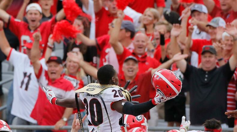 Georgia defensive back J.R. Reed (20) is lifted above his teammates after he scored on a sack and fumble by Florida's quarterback during the Bulldogs' 42-7 win in Jacksonville, Fla. (Bob Andres/bandres@ajc.com)