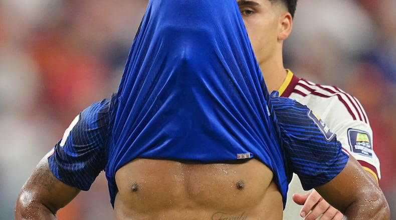 France's Desire Doue covers his face after his side's lost against in a World Cup semifinal soccer match in Arlington, Texas, near Dallas, Tuesday, July 14, 2026. (AP Photo/Julio Cortez)