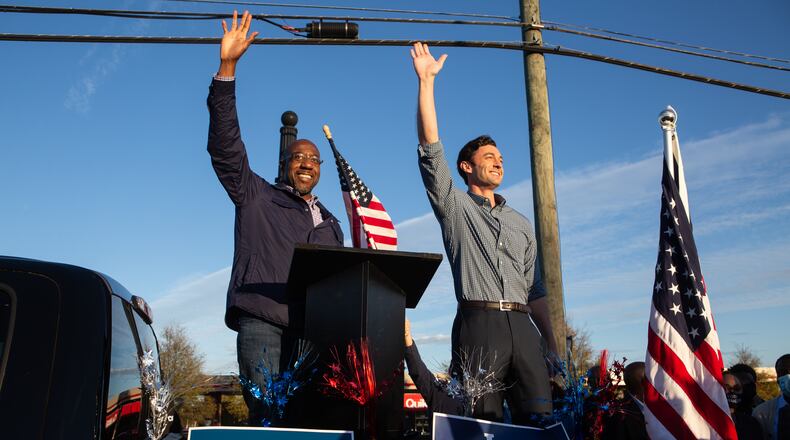 Democratic U.S. Senate candidates Jon Ossoff, right, and Raphael Warnock of Georgia wave to supporters during a rally on Nov. 15, 2020, in Marietta, Georgia. (Jessica McGowan/Getty Images/TNS)