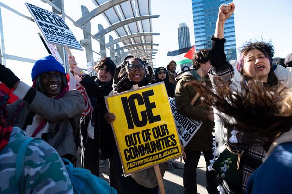 People join in a chant on the 17th Street bridge in Atlanta on Sunday. 