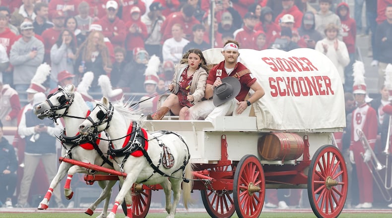 Members of the Oklahoma spirit groups drive the Sooner Schooner after a touchdown against Missouri during the first half of an NCAA college football game Saturday, Nov. 22, 2025, in Norman, Okla. (AP Photo/Alonzo Adams)