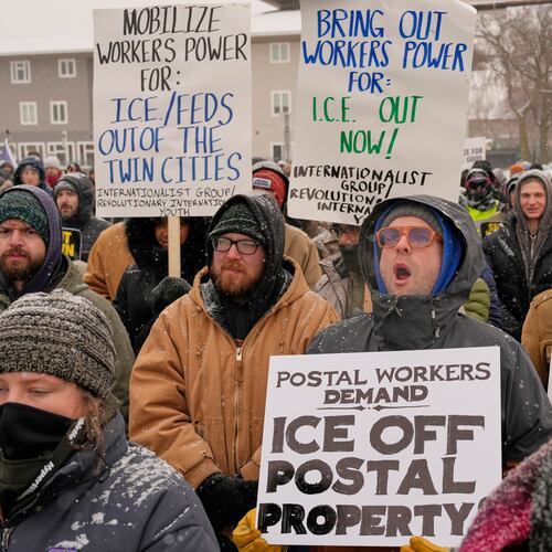 People march and gather near the post office during a protest, Sunday, Jan. 18, 2026, in Minneapolis. (AP Photo/Yuki Iwamura)