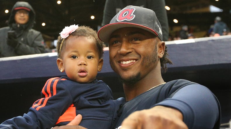 Ozzie Albies holds his sister Jeanalyn before Monday night’s game against the Yankees. (Curtis Compton/ccompton@ajc.com)