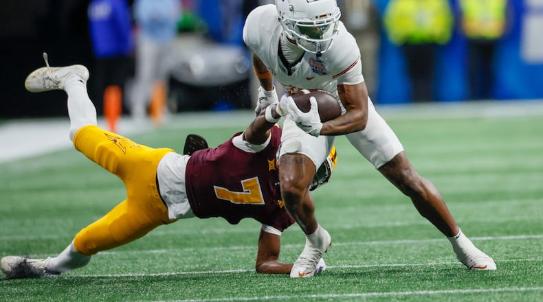 Texas Longhorns wide receiver Matthew Golden (2) avoids a tackle from Arizona State Sun Devils defensive back Shamari Simmons (7) during the second half of the 2025 Chick-fil-A Peach Bowl at Mercedes-Benz Stadium on Wednesday, Jan. 1, 2025, in Atlanta. (Miguel Martinez/AJC)