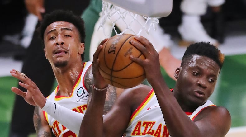 062321 Milwaukee: Atlanta Hawks defenders John Collins and Clint Capela goe up for the rebound against the Milwaukee Bucks in game 1 of the NBA Eastern Conference Finals at Fiserv Forum on Wednesday, June 23, 2021, in Milwaukee. “Curtis Compton / Curtis.Compton@ajc.com”