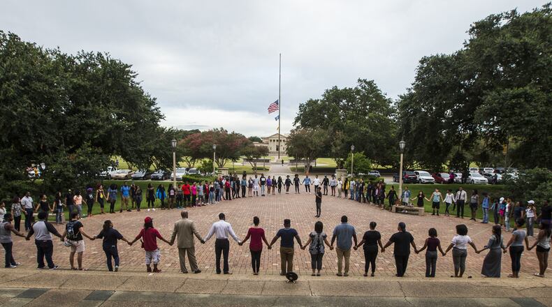 BATON ROUGE, LA -JULY 11: Students gather at a prayer vigil for Alton Sterling at the Memorial Tower on the Louisiana State University campus July 11, 2016 in Baton Rouge, Louisiana. Sterling was shot by a police officer in front of the Triple S Food Mart in Baton Rouge on July 5th, leading the Department of Justice to open a civil rights investigation. (Photo by Mark Wallheiser/Getty Images)