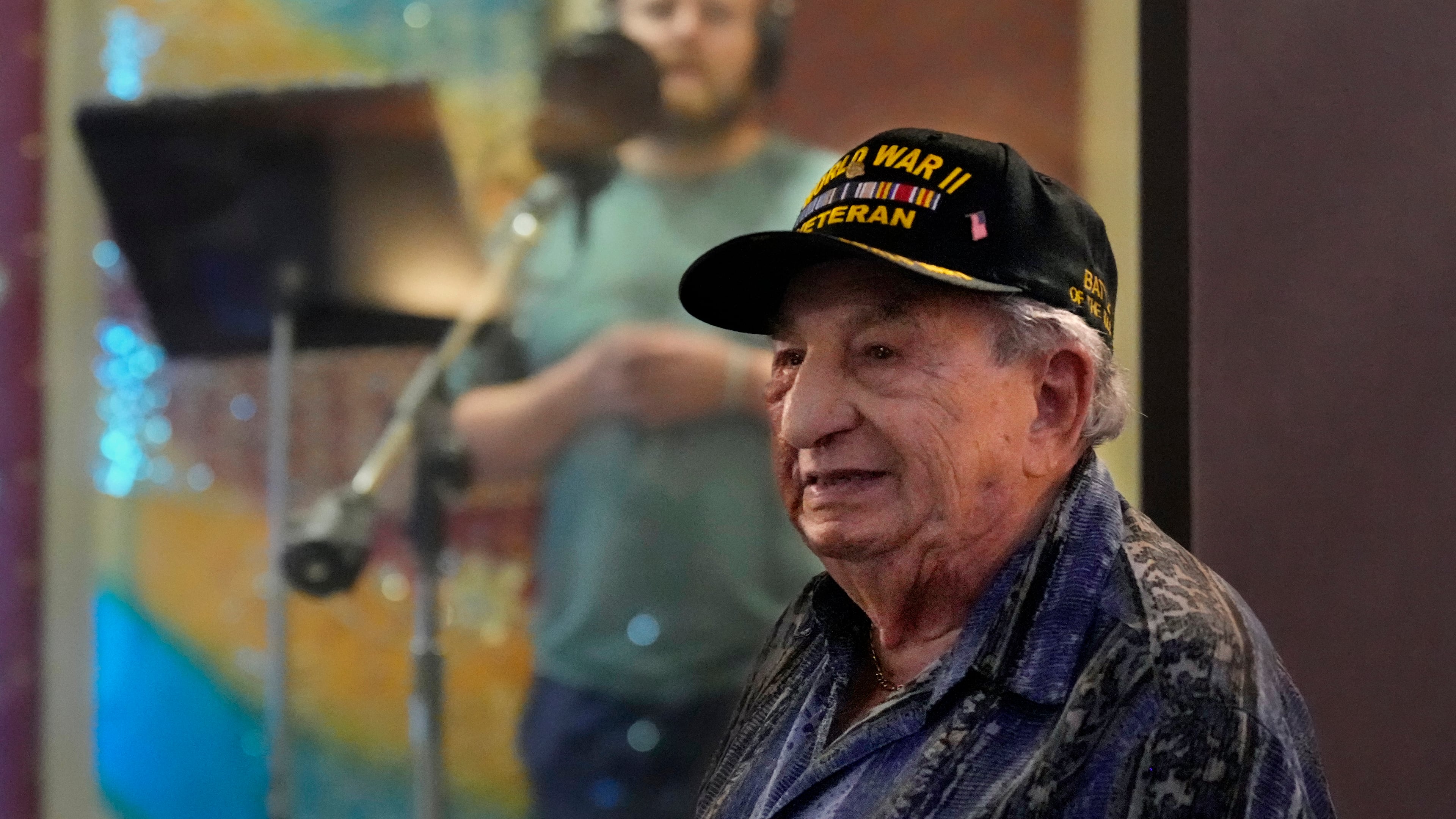 Irving Locker, a 101-year-old veteran of World War II, D-Day and the Battle of the Bulge, listens as Jesse Wayne Taylor, left, records a song based on Locker's military experience on Wednesday, Sept. 9, 2025, in Nashville, Tenn. (AP Photo/Mark Humphrey)