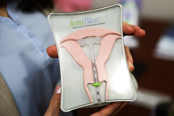 Kathy Lee-Sepsick, the founder of Femasys, holds a diagram for how FemBloc works at the company's facility in Suwanee on Wednesday, Sept. 24, 2025. A liquid polymer is injected into the fallopian tubes, then turns into a solid that irritates that tissue to the point where the body creates scar tissue that will build up enough to block sperm from reaching an egg. (Abbey Cutrer/AJC)