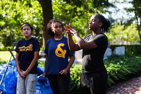 Oakland Roots Academy student Amelia Williams (right) speaks about the program at the Oakland Cemetery in Atlanta on Thursday, July 16, 2026. (Abbey Cutrer/AJC)