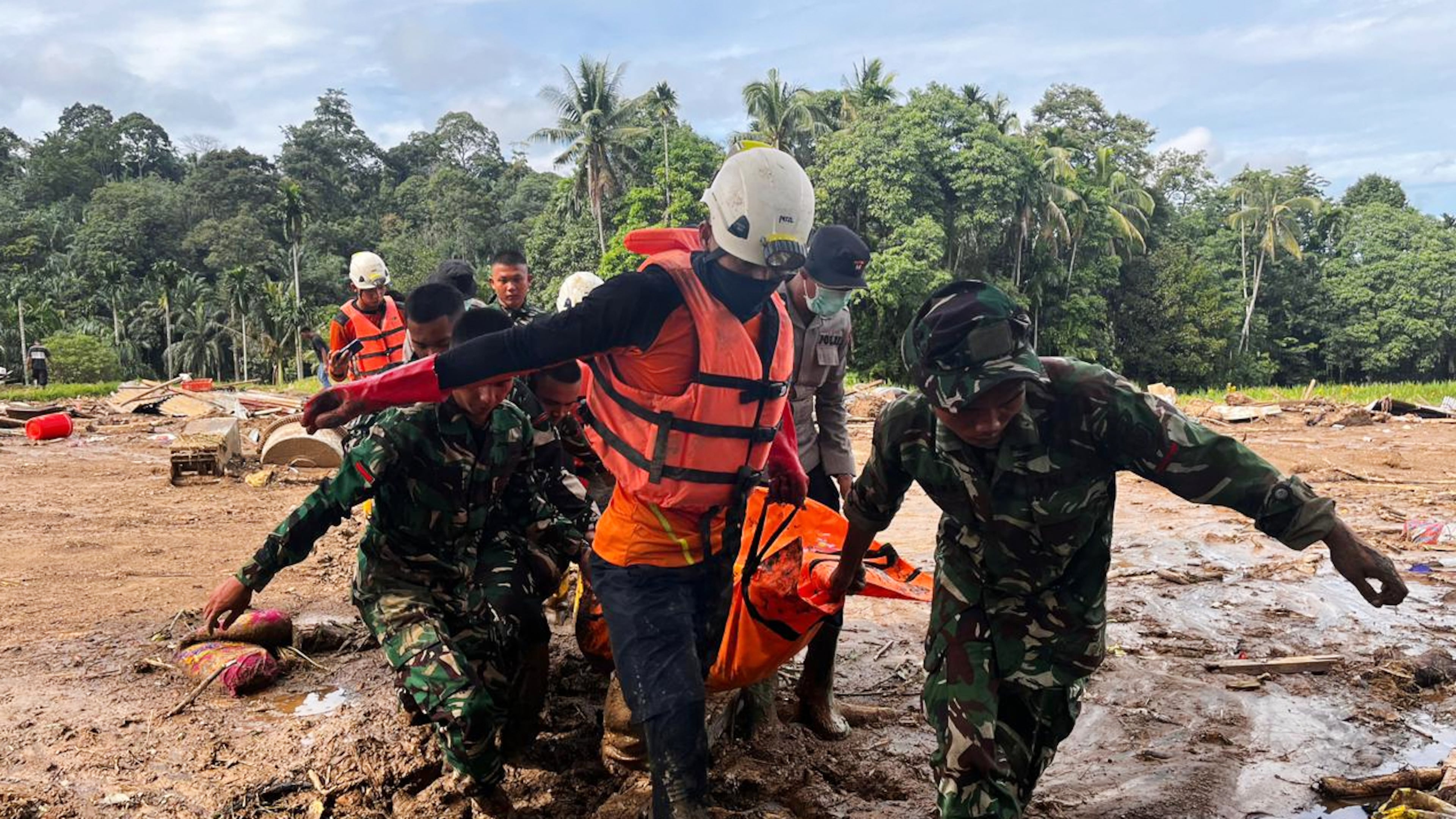 Rescuers carry the body of a flood victim, in Agam, West Sumatra, Indonesia, Sunday, Nov. 30, 2025. (AP Photo/Ade Yuandha)