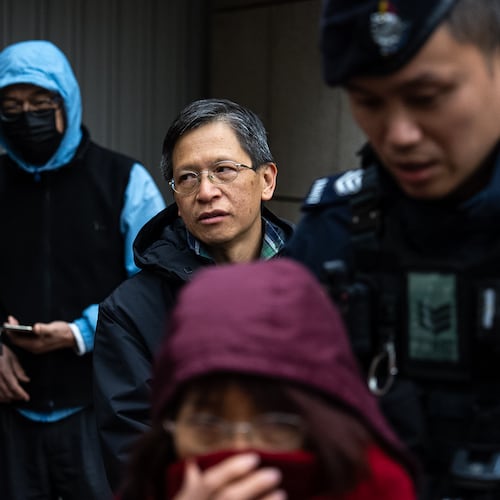 Pro-democracy activist Tang Ngok-kwan waits outside the West Kowloon Magistrates' Courts to attend a trial under a China-imposed national security law on Thursday, Jan. 22, 2026, in Hong Kong. (AP Photo/Chan Long Hei)