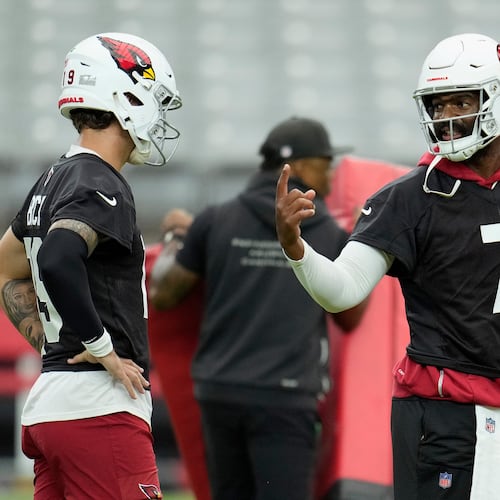 Arizona Cardinals quarterback Jacoby Brissett (7) talks with Cardinals quarterback Carson Beck, left, during NFL football training camp practice, Thursday, July 23, 2026, in Glendale, Ariz. (AP Photo/Ross D. Franklin)