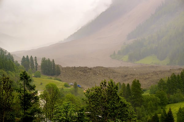A large avalanche with a mixture of ice, rock, snow and water reach the valley floor is pictured in Wiler after the Birch glacier collapsing above Blatten, Switzerland, Wednesday, May 28, 2025. (Jean-Christophe Bott/Keystone via AP)