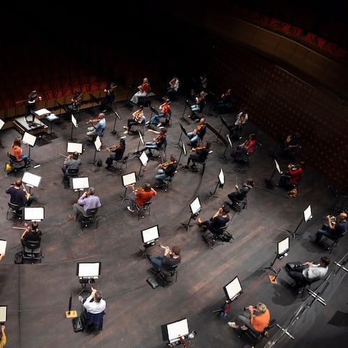 FILE - Chief Conductor Elim Chan, center top, conducts the Antwerp Symphony Orchestra through a rehearsal at the Queen Elisabeth Hall in Antwerp, Belgium, July 1, 2020. (AP Photo/Virginia Mayo, File)