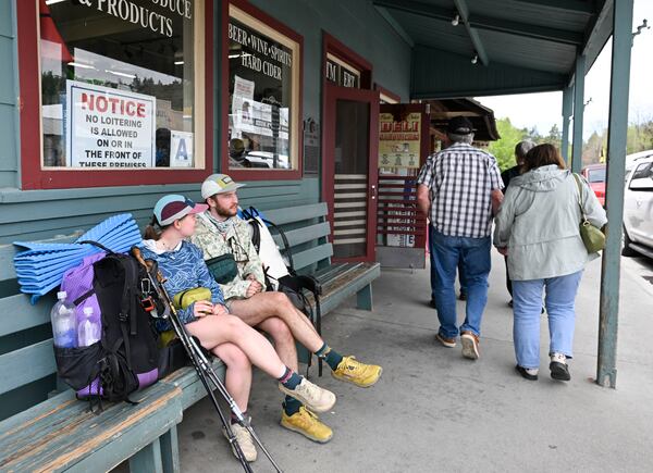 Celia Peterson, left, and Jensen Douillard wait before going on a hike Monday, April 14, 2025, in Julian, Calif., after an earthquake hit in San Diego County. (AP Photo/Denis Poroy)