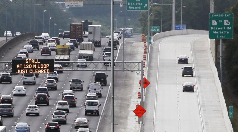 Southbound commuters on I-75 try the new Northwest Corridor Express Lanes as traffic backs up in Marietta Monday Morning. The lanes are free for the first two weeks (you still need a Peach Pass). After that, the minimum toll on the lanes for most of the day is 10 cents a mile. BOB ANDRES /BANDRES@AJC.COM