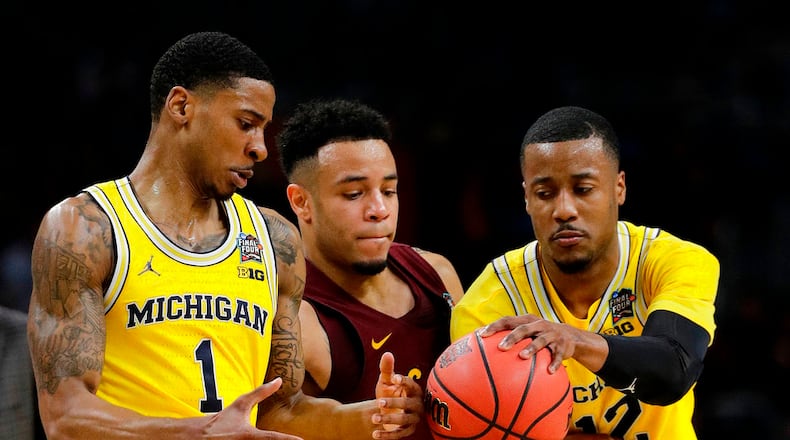 Loyola-Chicago's Marques Townes (5) battles for the ball against Michigan's Charles Matthews (1) and Charles Matthews (1) during the first half in the semifinals of the Final Four NCAA college basketball tournament, Saturday, March 31, 2018, in San Antonio. (AP Photo/David J. Phillip)