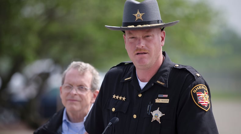 Pike County Sheriff Charles Reader speaks to the media alongside Ohio State Attorney General Mike DeWine during a news conference, Wednesday, April 27, 2016, in Waverly, Ohio. A coroner’s report released Tuesday showed new details of vicious violence in the shooting deaths of eight members of a rural southern Ohio family, finding most victims were shot three to nine times each and some of them were bruised. Meanwhile, the hunt for whoever is responsible continued to expand, with more than 200 law enforcement officials involved. (AP Photo/John Minchillo)