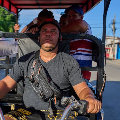 Liexer De La Cruz drives his tricycle with customers in Minas, Cuba's Havana province, Friday, Sept. 4, 2026. (AP Photo/Ramon Espinosa)