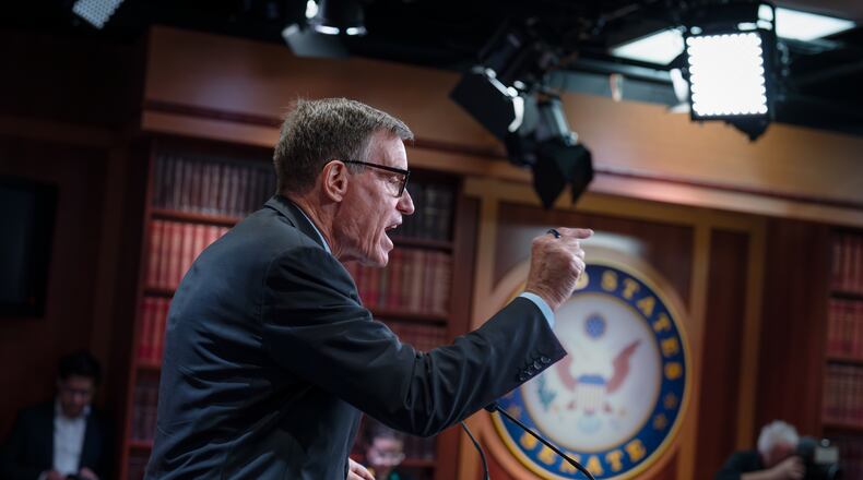 Sen. Mark Warner, D-Va., the top Democrat on the Senate Intelligence Committee, speaks about the Trump administration following reports that only Republican lawmakers received security briefings on the Trump-ordered military strikes against boats in the Caribbean, during a news conference at the Capitol in Washington, Thursday, Oct. 30, 2025. (AP Photo/J. Scott Applewhite)