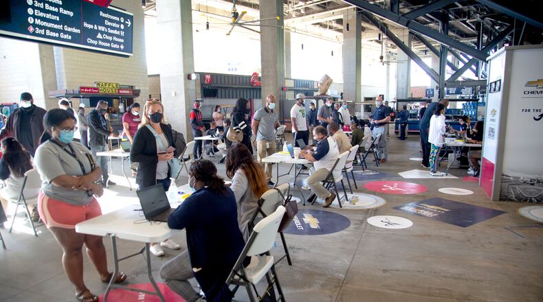 Deaths from COVID-19 have plunged in Georgia due to the early success of vaccination campaigns, experts say. Earlier this week, people lined up at a free vaccination clinic at Truist Park sponsored by the Atlanta Braves. (Photo: Steve Schaefer for The Atlanta Journal-Constitution)