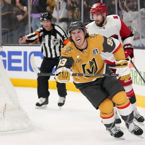 Vegas Golden Knights right wing Mitch Marner, left, celebrates his goal as Carolina Hurricanes defenseman Sean Walker, right, skates behind during the second period in Game 3 of the NHL hockey Stanley Cup Final series, Saturday, June 6, 2026, in Las Vegas. (AP Photo/John Locher)