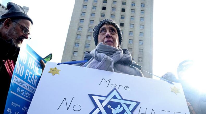 Margo Litwin joins others in a Jan. 5 march across the Brooklyn Bridge to support the city’s Jewish communities in the wake of a spate of anti-Semitic attacks, in New York. Thousands of people, some covered in Israeli flags and others singing Hebrew songs, poured into Lower Manhattan on Sunday in a show of solidarity. YANA PASKOVA/THE NEW YORK TIMES