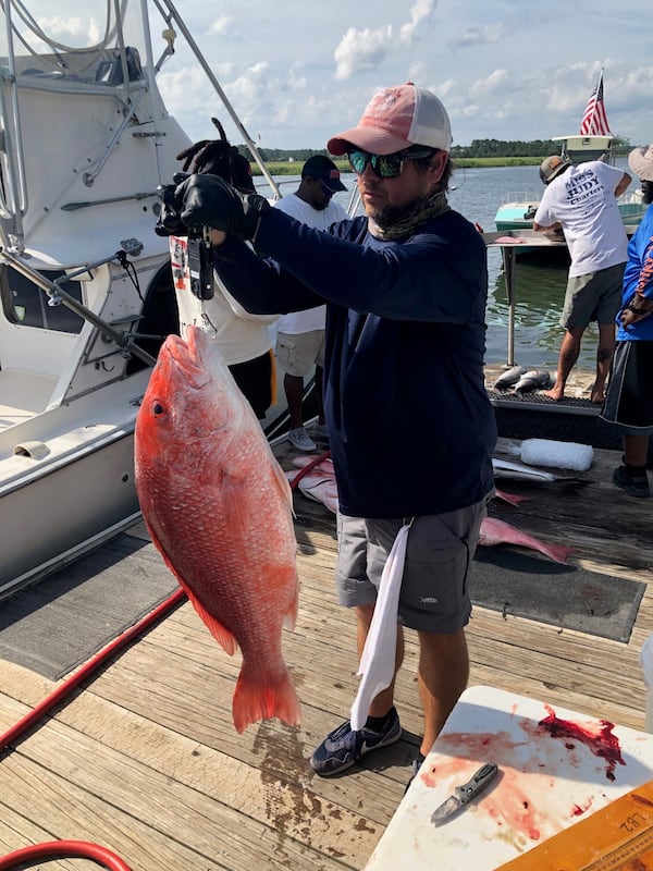 A Georgia Department of Natural Resources staffer weighs a red snapper. (Photo courtesy of Georgia Department of Natural Resources)
