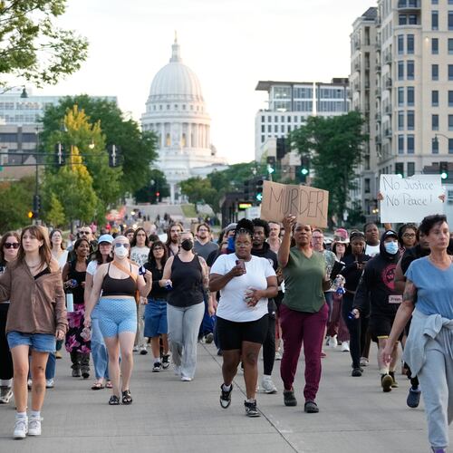 Protesters march after a Madison police officer shot and killed a man Wednesday, July 22, 2026, in Madison, Wis. (AP Photo/Kayla Wolf)