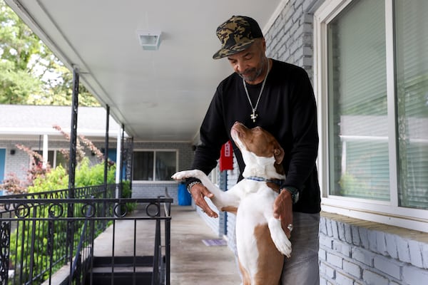 Willie Jeffries plays with his dog, Pipe Pipe, while taking a break from moving out of his apartment on Thursday, May 8, 2025, in Atlanta. Before living in the apartment, Jeffries had lived in the sprawling Cooper Street encampment. (Jason Getz/AJC)
