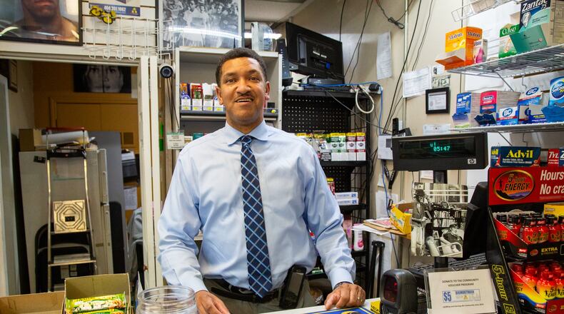 Ben Graham was a drug addict for 17 years and lived under the bridges on Auburn Ave before turning his life around. Now he owns the Big-Mouth Ben Convenience store on Auburn Ave & he is a motivational entertainer/speaker. He has a yellow bike in front of the store with an invitation to come inside & hear his story. (Photo by Phil Skinner)