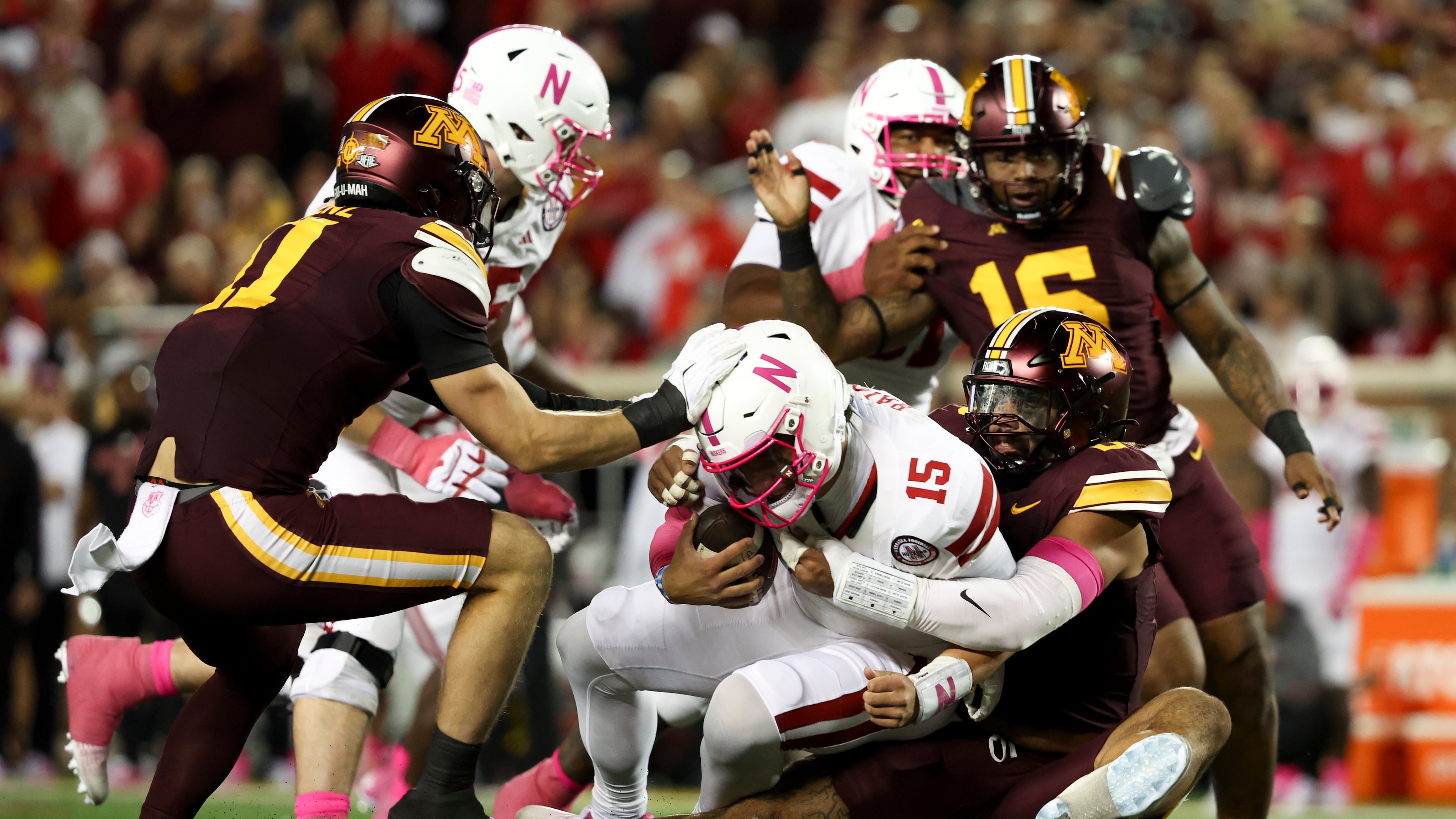 Minnesota defensive lineman Anthony Smith, right, sacks Nebraska quarterback Dylan Raiola (15) during the first half of an NCAA college football game, Friday, Oct. 17, 2025, in Minneapolis. (AP Photo/Ellen Schmidt)