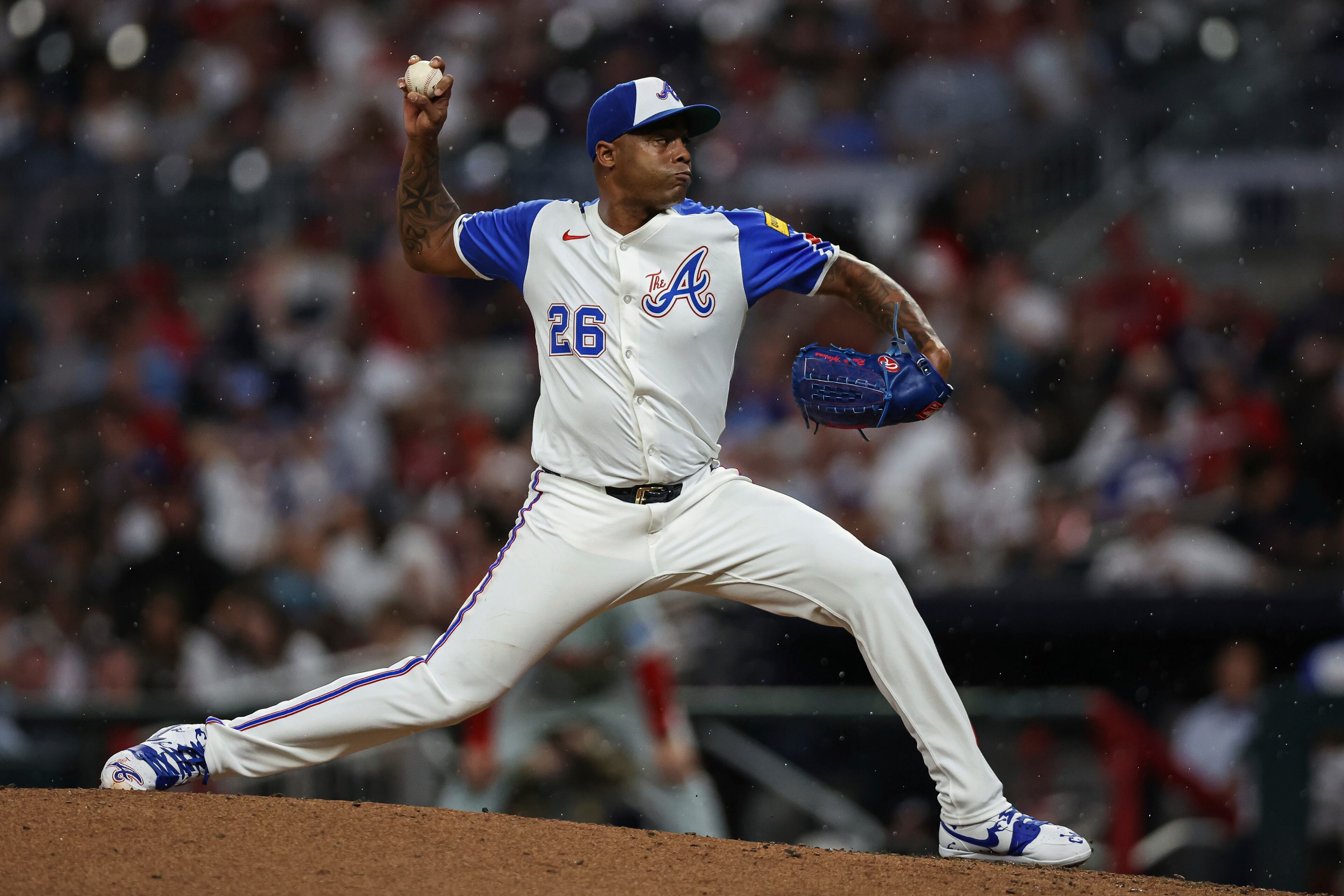 Atlanta Braves pitcher Raisel Iglesias (26) delivers in the eighth inning of a baseball game against the Philadelphia Phillies, Saturday, June 28, 2025, in Atlanta. (AP Photo/Colin Hubbard)