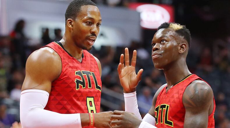 Atlanta Hawks Dwight Howard and Dennis Schroder confer after a miscommunication during a game against the Brooklyn Nets on Sunday, March 26, 2017, in Atlanta.