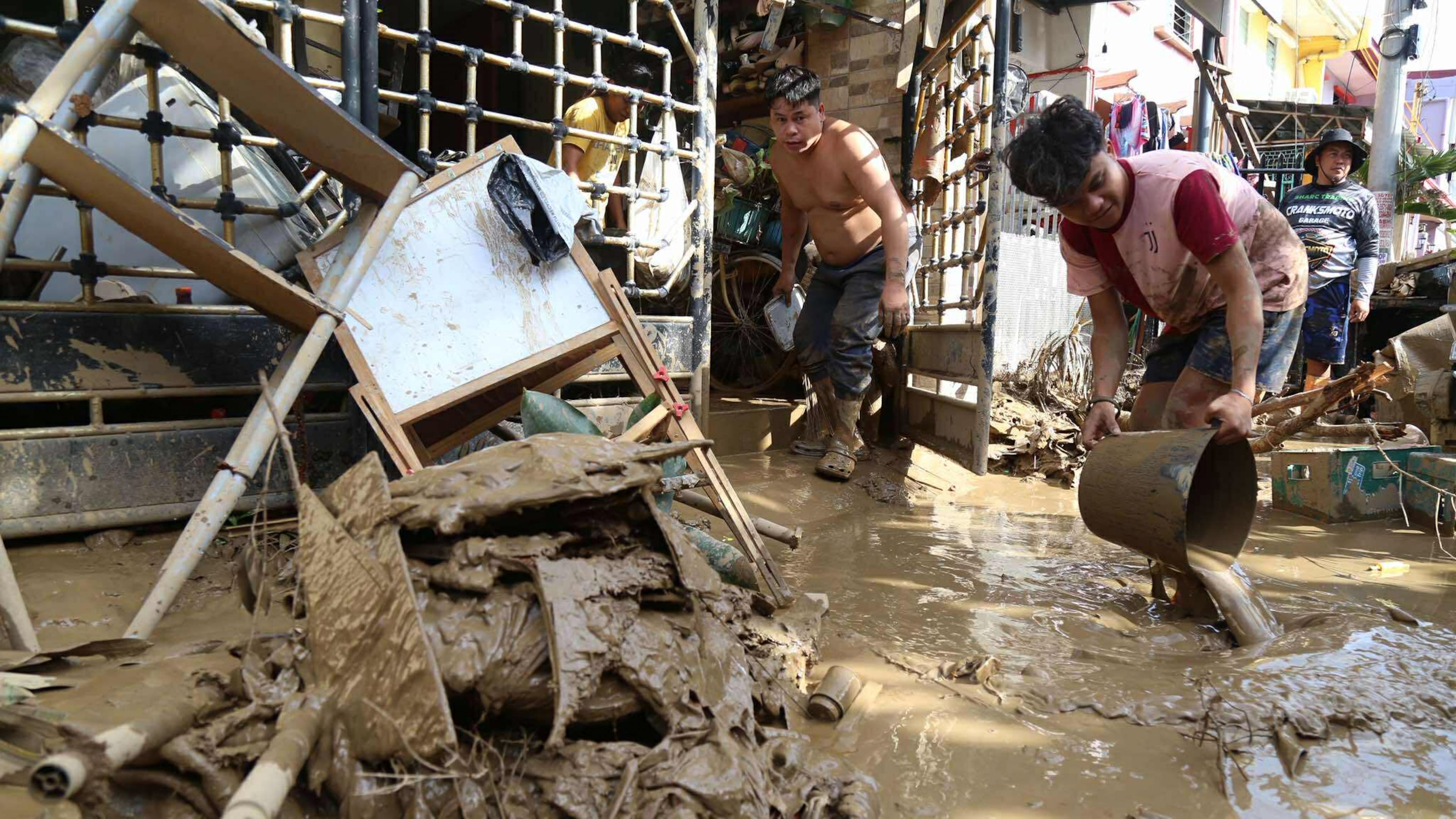 Residents clean up outside their homes after Typhoon Kalmaegi caused devastation in communities at Talisay City, Cebu province, central Philippines, Wednesday, Nov. 5, 2025. (AP Photo/Jacqueline Hernandez)